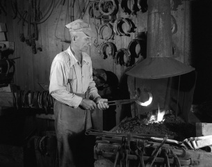 One of the last vestiges of traditional smithing in Quebec: Joseph-Louis Paquet in his workshop, Saint-Côme, 1952