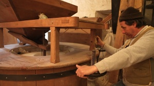 The miller at the Légaré Mill adjusts the mix for buckwheat flour