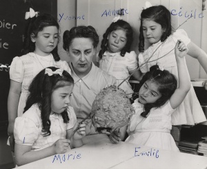 Gaëtane Vézina, surrounded by the famous Dionne quintuplets, who signed their names on the original photograph, Callander, Ontario, between 1938 and 1942